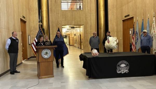 Lieutenant Governor Michelle Strinden and Deputy Ag Commissioner Tom Bodine with the pardoned turkey.