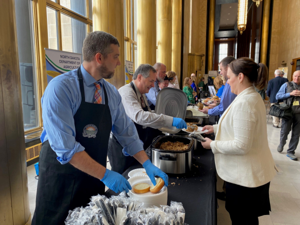 Ag Commissioner Doug Goehring and other ND Ag Department staff serve a meal at ND Ag Day at the Capitol