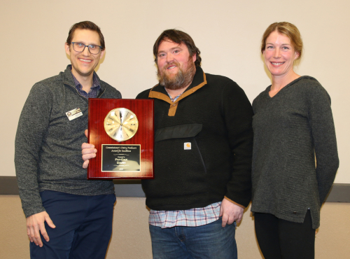 Jonas and Sam Heyl of Pay-Dak Dairy accept the Commissioner's Award of Dairy Excellence from North Dakota Department of Agriculture representative Nathan Kroh.